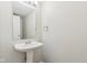 Small bathroom with pedestal sink and mirror at 1127 Maple Stream Dr, Indianapolis, IN 46217