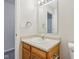 Small bathroom with wood vanity, single sink, and mirror at 1127 Maple Stream Dr, Indianapolis, IN 46217