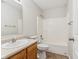 Clean bathroom with a tub, toilet and wood vanity at 1127 Maple Stream Dr, Indianapolis, IN 46217