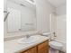 Simple bathroom with wood vanity, toilet, and a tub at 1127 Maple Stream Dr, Indianapolis, IN 46217