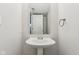 Clean bathroom with pedestal sink and mirror at 1127 Maple Stream Dr, Indianapolis, IN 46217