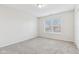 Well-lit bedroom with grey carpet and a window at 1127 Maple Stream Dr, Indianapolis, IN 46217