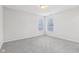 Bedroom with gray carpet and two windows at 1127 Maple Stream Dr, Indianapolis, IN 46217