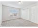 Spacious bedroom with grey carpet, double door closet, and window at 1127 Maple Stream Dr, Indianapolis, IN 46217