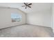 Bright bedroom with vaulted ceiling, ceiling fan, grey carpet and window at 1127 Maple Stream Dr, Indianapolis, IN 46217