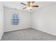 Bedroom with gray carpet, ceiling fan and window at 1127 Maple Stream Dr, Indianapolis, IN 46217