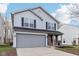Two-story house with gray siding, brick accents, and a two-car garage at 1127 Maple Stream Dr, Indianapolis, IN 46217