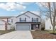 Two-story house with gray siding, brick accents, and a two-car garage at 1127 Maple Stream Dr, Indianapolis, IN 46217