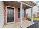 Brick front porch with black door and white columns at 1127 Maple Stream Dr, Indianapolis, IN 46217