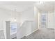 Upstairs hallway with grey carpet, neutral walls, and a window at 1127 Maple Stream Dr, Indianapolis, IN 46217