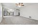 Open concept living room and kitchen with ceiling fan and grey carpet at 1127 Maple Stream Dr, Indianapolis, IN 46217