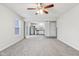 Living room with open kitchen, ceiling fan and grey carpet at 1127 Maple Stream Dr, Indianapolis, IN 46217