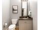 Small bathroom with granite countertop and toilet at 220 N East St, Indianapolis, IN 46204