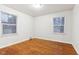 Spacious bedroom with hardwood floors and two windows at 2314 E 58Th St, Indianapolis, IN 46220