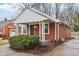 Red brick ranch house with a covered porch and mature trees at 2314 E 58Th St, Indianapolis, IN 46220