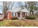 Brick ranch house with a covered porch and well-maintained landscaping at 2314 E 58Th St, Indianapolis, IN 46220