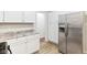 Updated kitchen, featuring stainless steel fridge and white cabinets at 2314 E 58Th St, Indianapolis, IN 46220