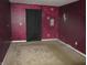 Burgundy walls and carpeted floor in this bedroom with a closet at 317 N Bradley Ave, Indianapolis, IN 46201