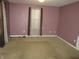Simple carpeted bedroom with mauve walls and window at 317 N Bradley Ave, Indianapolis, IN 46201