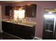 Dark brown cabinets and stainless steel appliances in this galley kitchen at 317 N Bradley Ave, Indianapolis, IN 46201