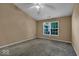 Well-lit bedroom with grey carpeting and a ceiling fan at 5849 Jamestown Square Ln, Indianapolis, IN 46234