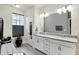 Elegant bathroom featuring double sinks and a large mirror at 597 Steinbeck Pl, Carmel, IN 46032