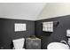 Modern bathroom with dark vanity and corner sink at 597 Steinbeck Pl, Carmel, IN 46032