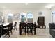 Spacious dining area with dark wood table and hardwood floors at 597 Steinbeck Pl, Carmel, IN 46032