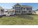 Expansive backyard with a deck, white pergola, patio area, and views of the surrounding greenery and blue siding at 78 Chatham Brook Dr, Westfield, IN 46074