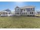 Expansive backyard with a covered patio and a well-maintained lawn, great for outdoor entertaining and relaxation at 78 Chatham Brook Dr, Westfield, IN 46074