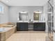 Elegant bathroom with double vanities, soaking tub, and a glass-enclosed shower at 78 Chatham Brook Dr, Westfield, IN 46074