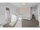 A charming Bedroom with floral wallpaper, white crib, and ample natural light creates a soothing space at 78 Chatham Brook Dr, Westfield, IN 46074