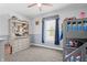 A well-lit bedroom featuring a bookshelf, bunk bed and natural light from a window with blue curtains at 78 Chatham Brook Dr, Westfield, IN 46074