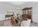 Formal dining room with hardwood floors, wainscoting, elegant lighting, and a china cabinet at 78 Chatham Brook Dr, Westfield, IN 46074