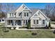 Beautiful two-story home boasts stone accents, a covered front porch, manicured lawn, and tasteful landscaping at 78 Chatham Brook Dr, Westfield, IN 46074