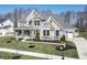 Stunning two-story home boasts a landscaped yard, stone accents, a charming porch, and a well-manicured lawn at 78 Chatham Brook Dr, Westfield, IN 46074