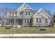 Charming two-story home featuring a stone facade, inviting front porch, and beautifully landscaped front yard at 78 Chatham Brook Dr, Westfield, IN 46074