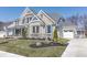 Gorgeous two-story home with stone and brick accents, a cozy front porch, and a spacious driveway at 78 Chatham Brook Dr, Westfield, IN 46074
