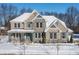 Two-story home with stone and brick exterior, covered porch, and snow-covered landscaping at 78 Chatham Brook Dr, Westfield, IN 46074