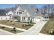 Expansive two-story home showcasing stone and siding, a pristine lawn, mature trees, and a private driveway at 78 Chatham Brook Dr, Westfield, IN 46074