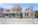 Two-story home with stone and brick exterior, covered porch, and snow-covered landscaping at 78 Chatham Brook Dr, Westfield, IN 46074