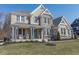 Beautiful two-story home featuring stone accents, a cozy front porch with rocking chairs, and manicured lawn at 78 Chatham Brook Dr, Westfield, IN 46074