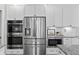 Kitchen appliances including stainless steel refrigerator, oven, and microwave with white cabinets at 78 Chatham Brook Dr, Westfield, IN 46074