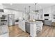 Spacious kitchen with stainless steel appliances, a large island with seating, and hardwood floors at 78 Chatham Brook Dr, Westfield, IN 46074