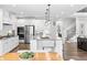 Open kitchen with white cabinets, granite countertops, stainless steel appliances, and a central island at 78 Chatham Brook Dr, Westfield, IN 46074