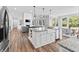 Open concept kitchen with island seating and sink, flowing seamlessly into the living area at 78 Chatham Brook Dr, Westfield, IN 46074