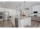 Island kitchen with stainless steel appliances and white shaker cabinets at 78 Chatham Brook Dr, Westfield, IN 46074