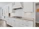 White kitchen with gas cooktop, herringbone backsplash, and pantry at 78 Chatham Brook Dr, Westfield, IN 46074