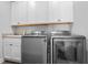 Laundry room with modern washer, dryer, and upper cabinets at 78 Chatham Brook Dr, Westfield, IN 46074