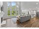 Open concept living room features a fireplace, high windows, hardwood floors, and modern furnishings at 78 Chatham Brook Dr, Westfield, IN 46074